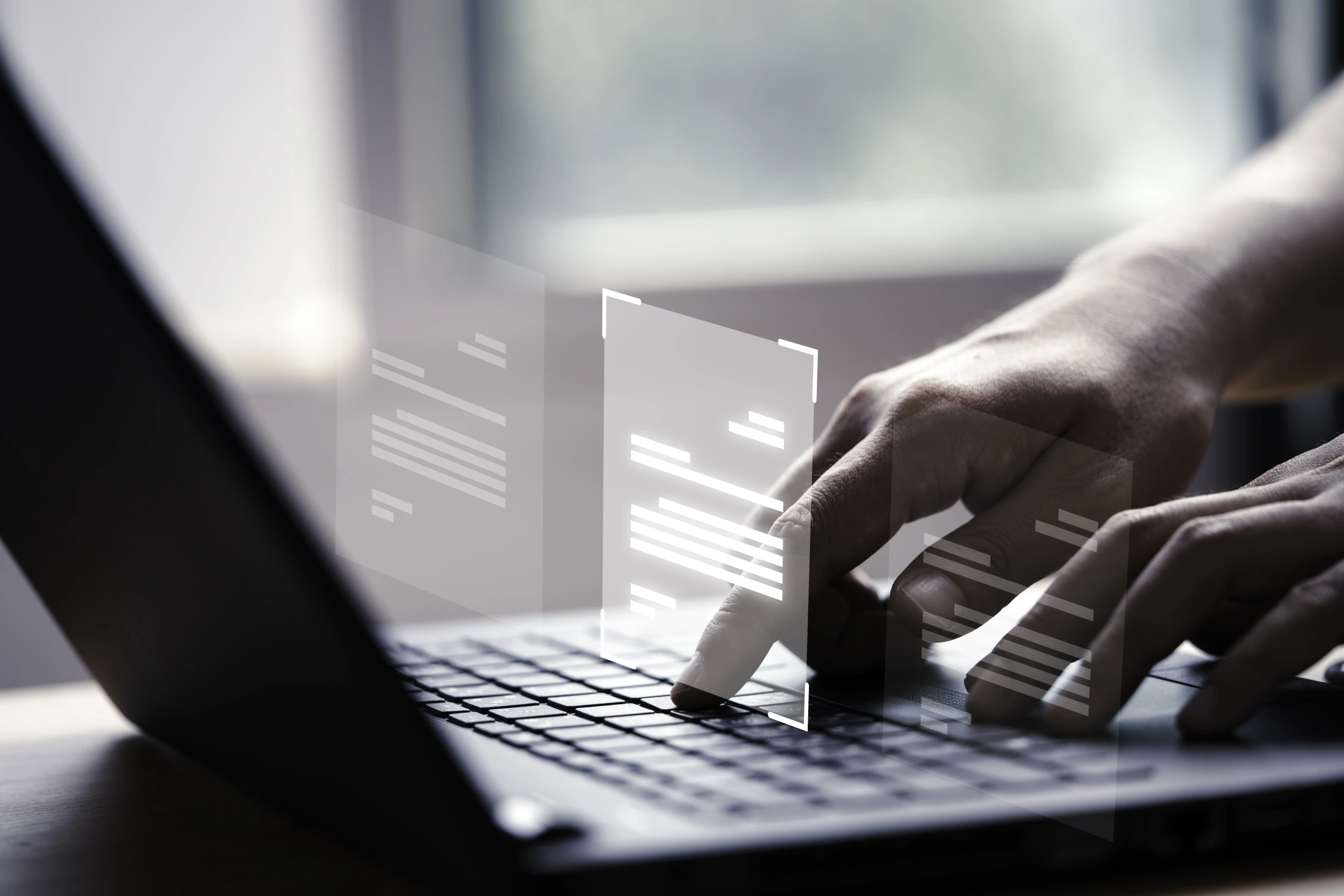 Hands using a laptop with digital document approval panels